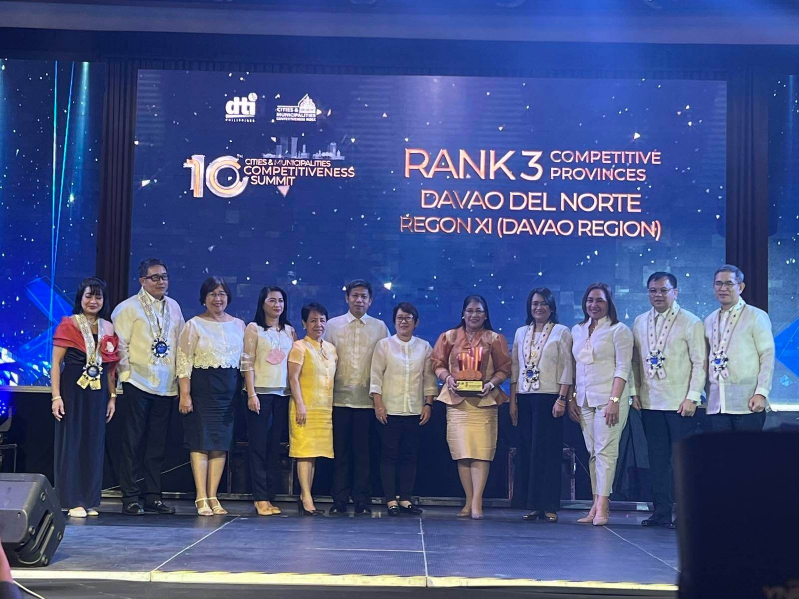 Provincial Administrator Engr. Josie Jean Rabanoz, center, receives the award recognizing Davao del Norte as 3rd Most Competitive Province in the country.